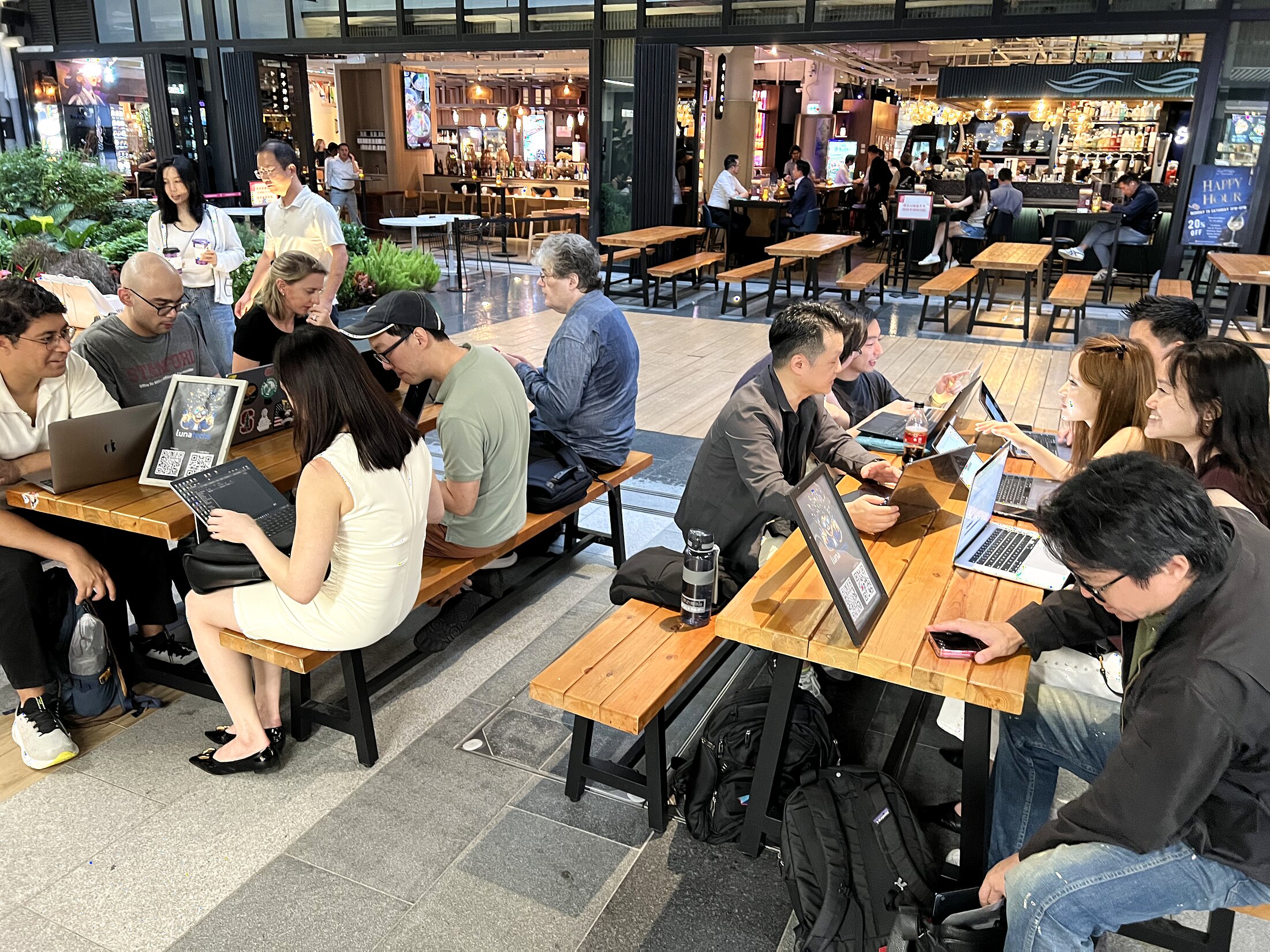 Builders spread across Central Market tables with laptops open