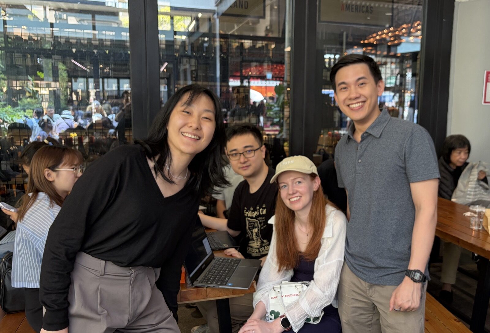 Claude Code Community Day attendees smiling with laptops at Central Market