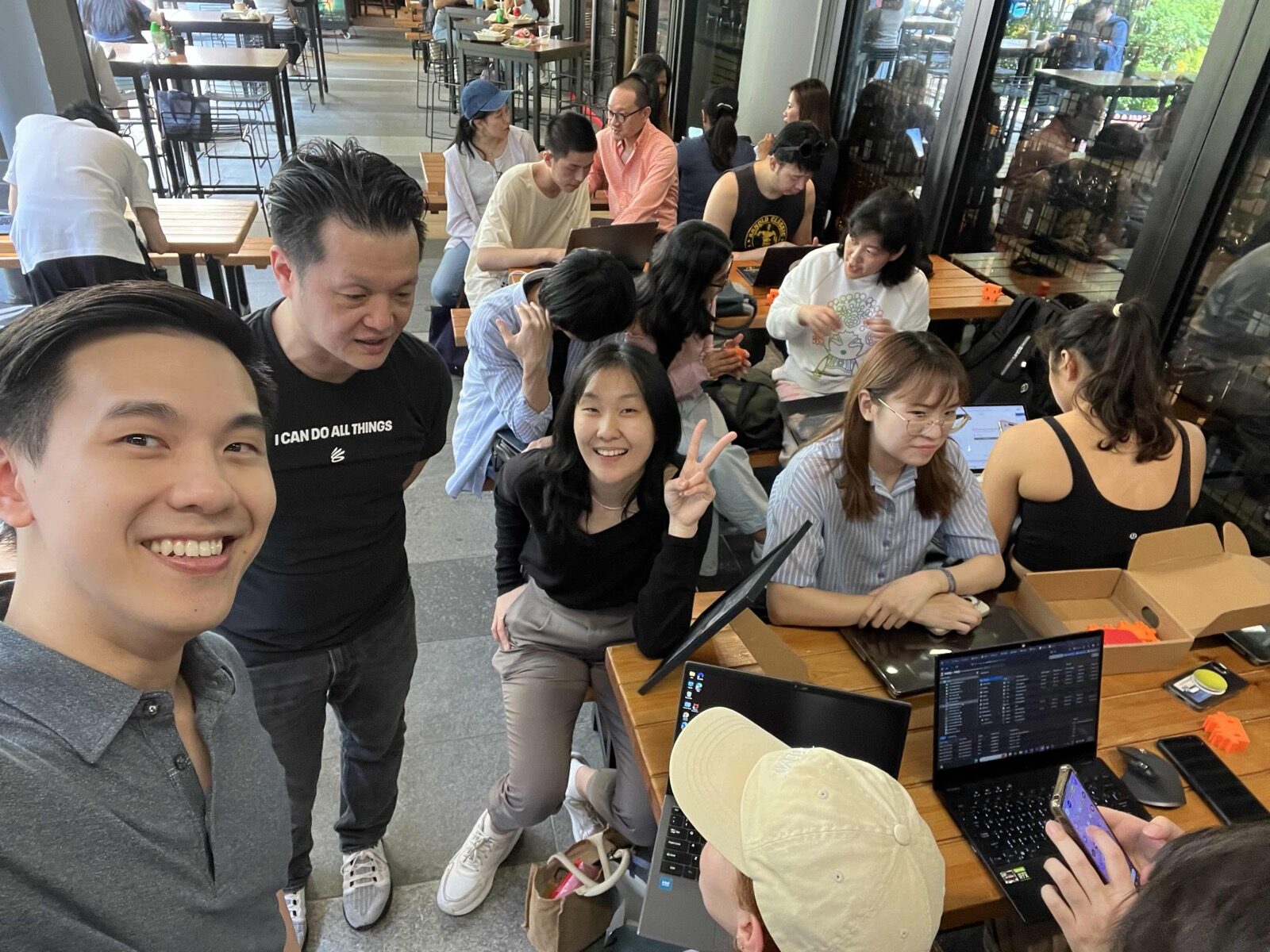 Eric and attendees at tables with laptops during Claude Code Community Day