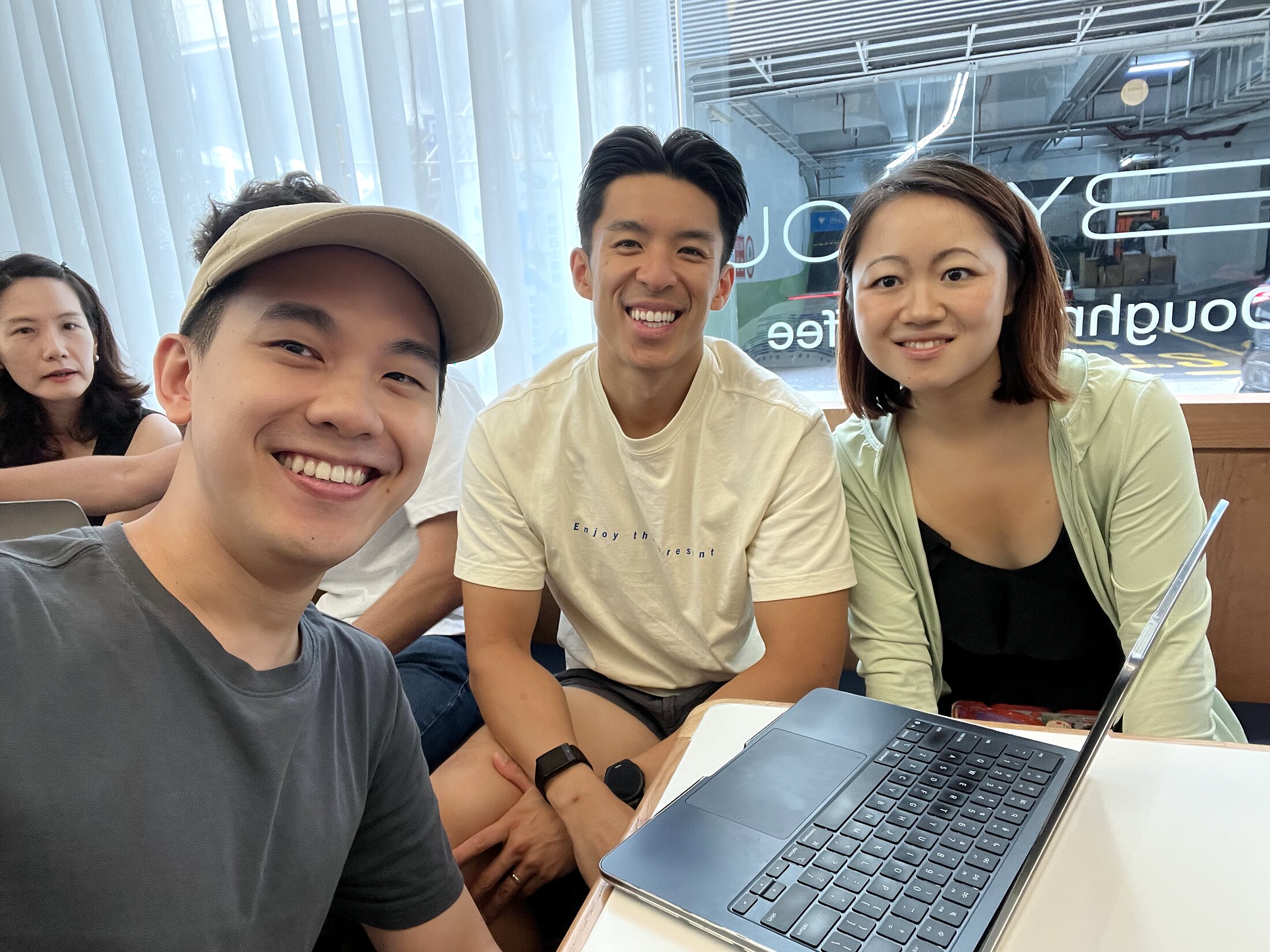 Eric Wong with attendees around a laptop table during the DeepSeek OpenCode session